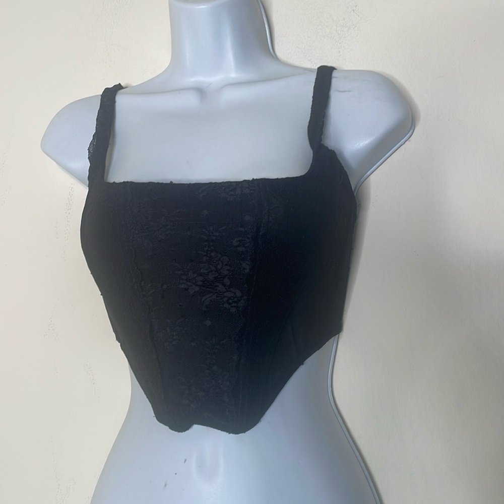 Out from under small black corset​